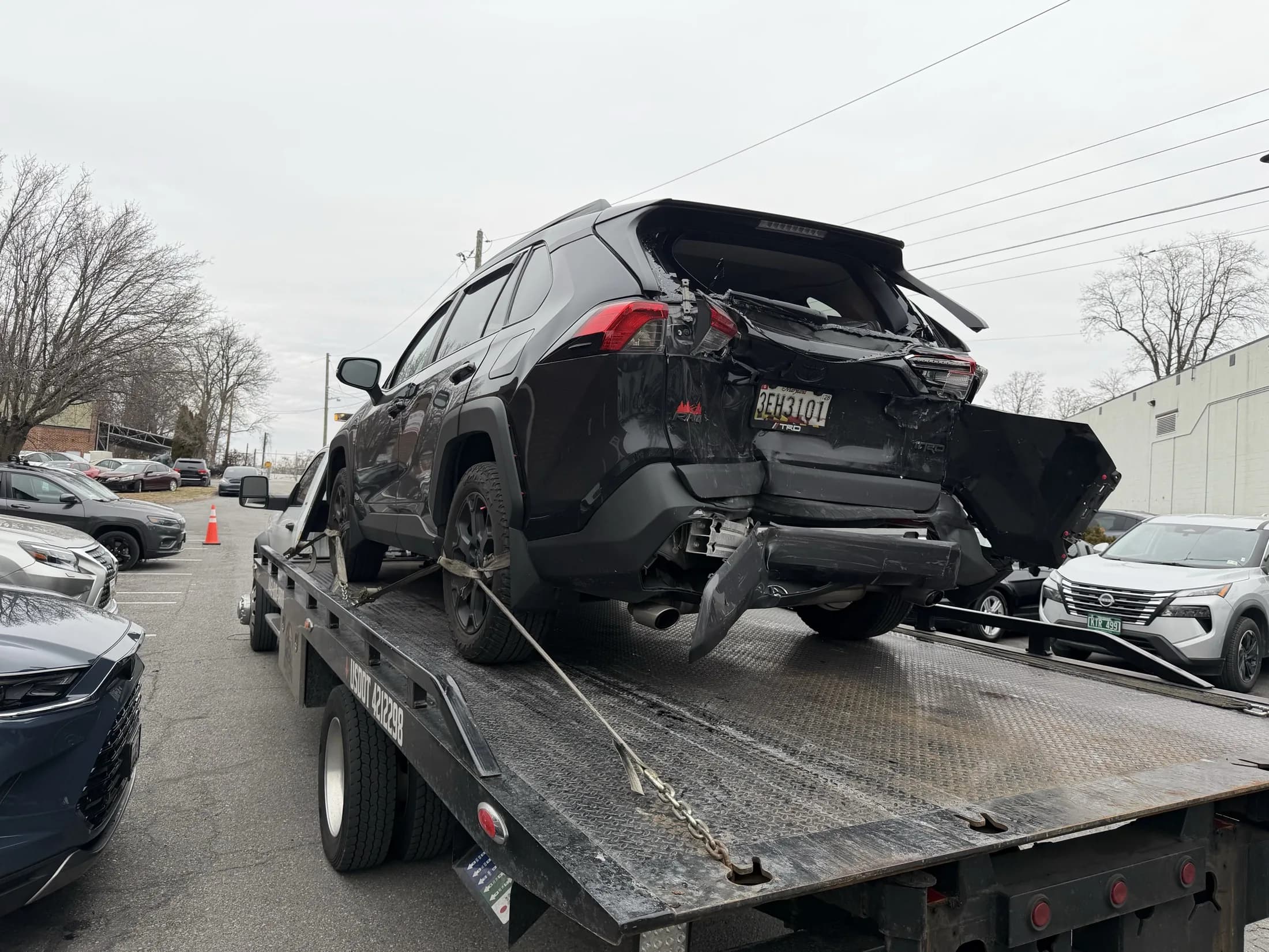 Damaged SUV loaded on a tow truck for recovery